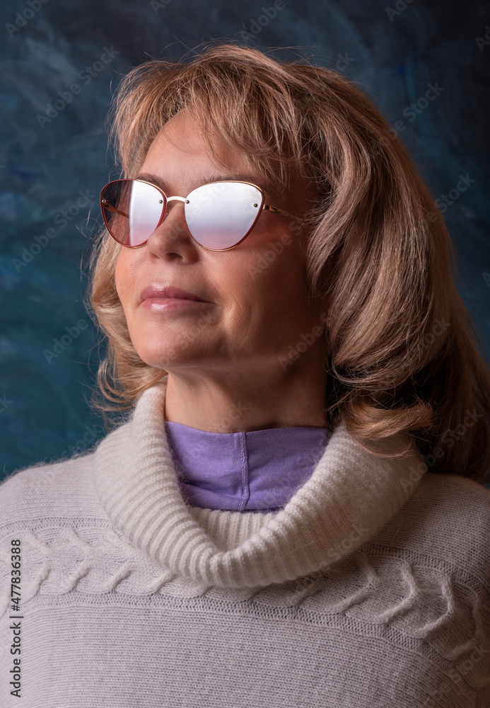 Portrait of a beautiful mature woman in sunglasses.