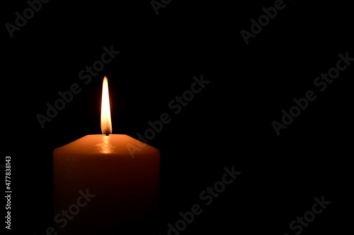 burning candles close-up on black background