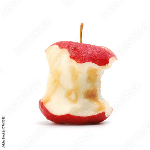 A juicy red apple that has been bitten to the core. Fruit is eaten on a white background.