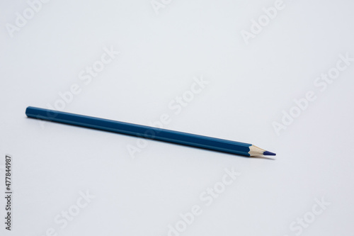 Blue pencil on a white background. 