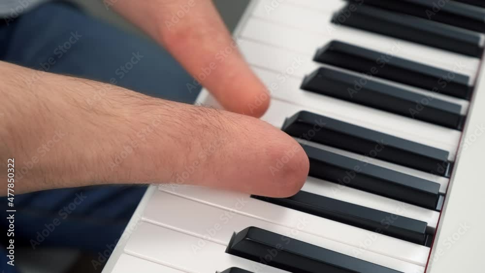 Disabled young man with amputated two stump hands is playing piano, hands closeup. Life of a handicapped guy person musician with disabilities. He's trying to keep playing after the injury. Disabled young man with amputated two stump hands is playing piano, hands closeup. Life of a handicapped guy person musician with disabilities. He's trying to keep playing after the injury.