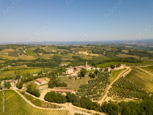 Aerial/Drone Panorama of Tuscany landscape with vineyards and olive trees - With Montauto castle and San Gimignano - Italy 