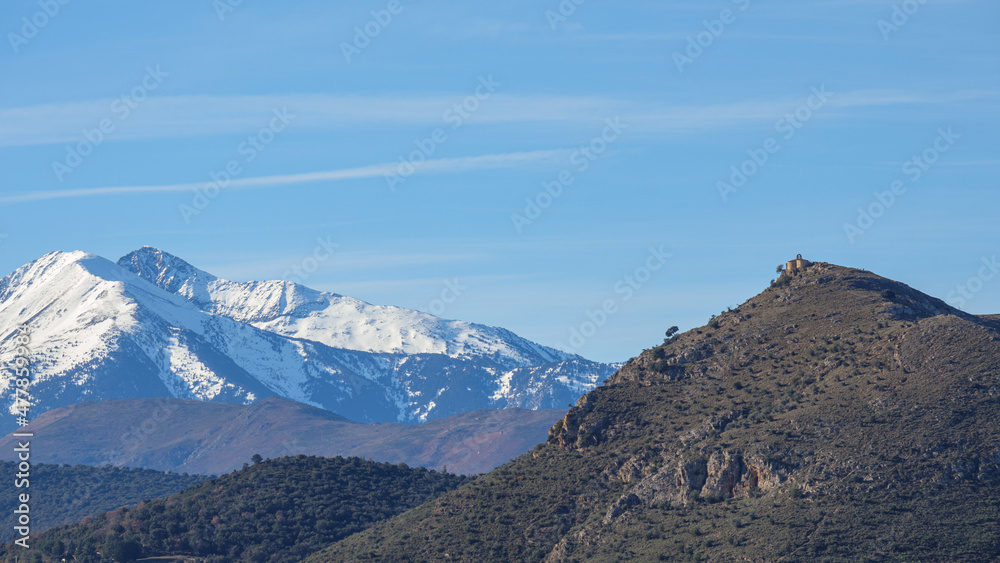 panorama of a small chapel and snowy Canigou