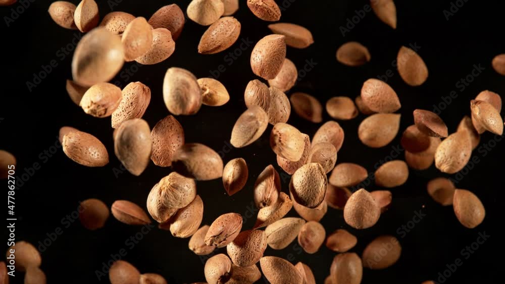 Super Slow Motion Shot of Flying Whole Almond Nuts Towards Camera Isolated on Black at 1000fps. Super Slow Motion Shot of Flying Whole Almond Nuts Towards Camera Isolated on Black at 1000fps.