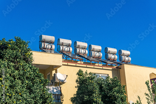 solar thermal water heating collector on the roof of the house photo