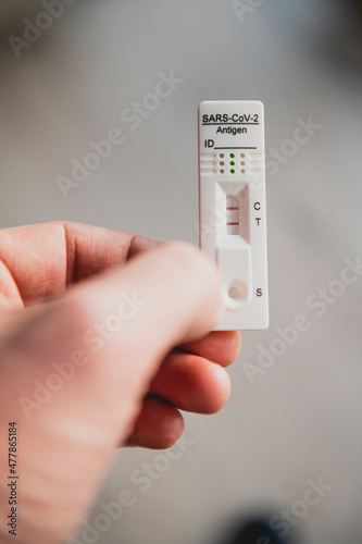 Hand holding positive covid rapid self test
