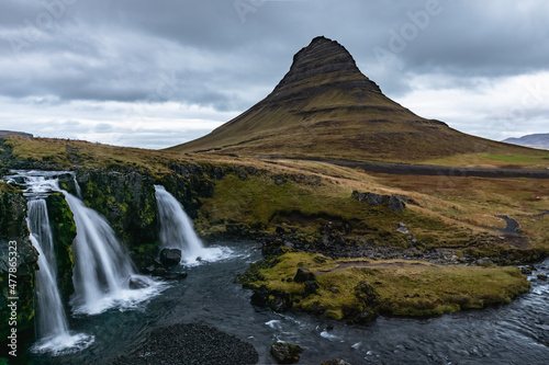 Beautiful rugged Icelandic landscape with horses and waterfalls typical of the area