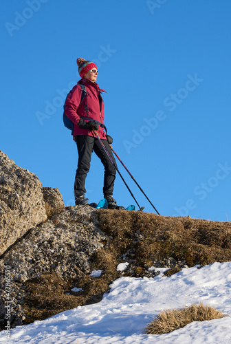 nice and active senior woman snowshoeing in in the Allgau alps above Immenstadt, Bavaria, Germany 