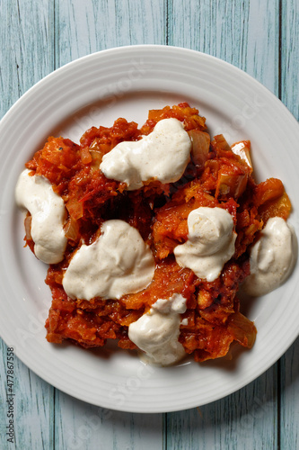 Curry with butternut squash and tomatoes, served with garlic raita with yogurt. View from above.  photo