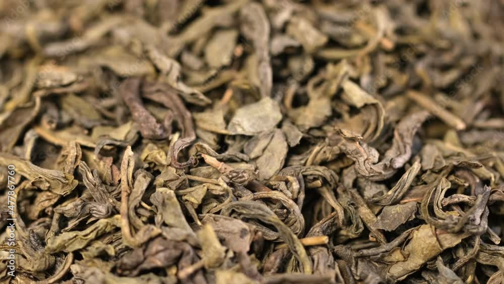Natural Green Tea, Macro, Dry Healthy Herbs, Isolated, Rotation. Background of Green Tea, Dried Herbs. Healthy food concept Natural Green Tea, Macro, Dry Healthy Herbs, Isolated, Rotation. Background of Green Tea, Dried Herbs. Healthy food concept