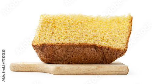 Slice of pandoro on wooden cutting board isolated on white background, close-up. photo