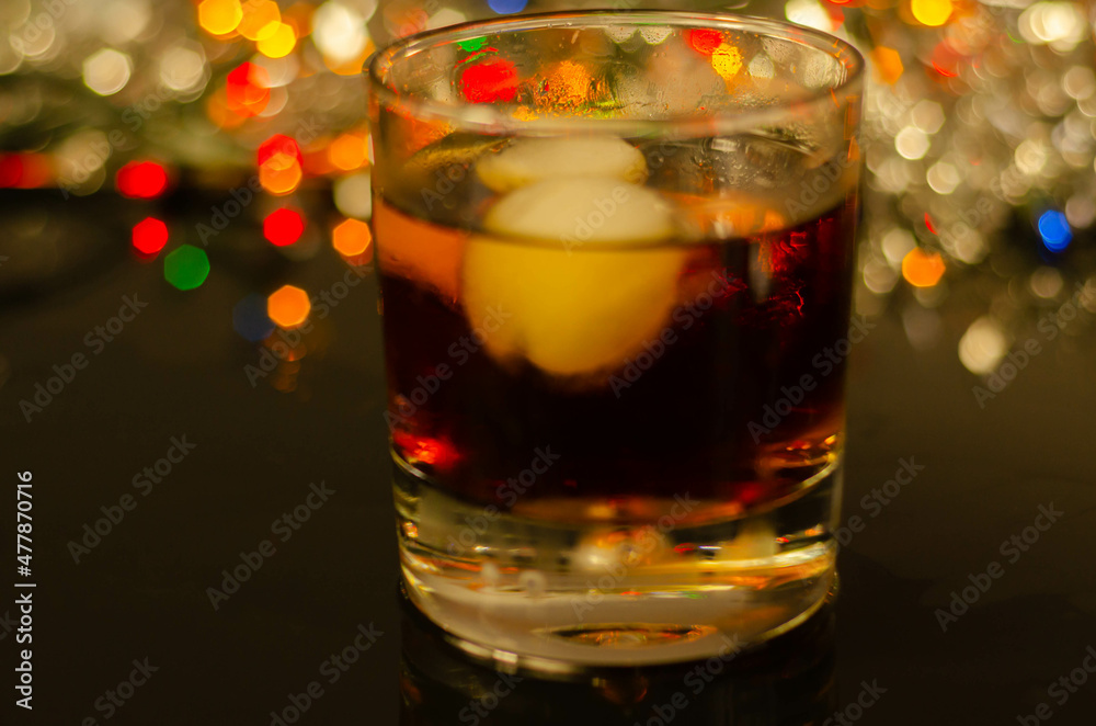 Drink Cuba Libre, rum with cola in an old fashoned glass with two ice balls