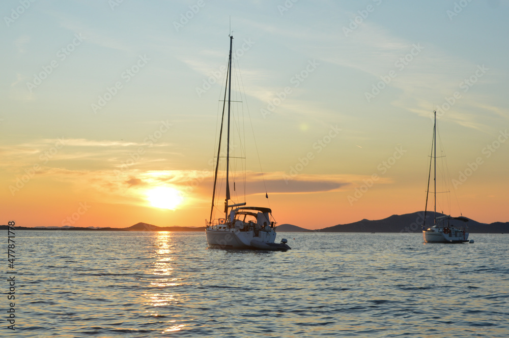 Two sailboats at Adriatic sea, sailing into the sunset  in Croatia, near Zadar and Kornati islands