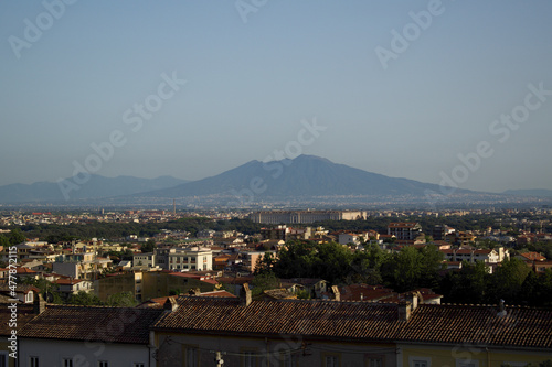 panorama of the royal palace of caserta with the Vesuvius volcano in the background