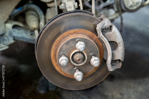 Vehicle's disc brake inspection and maintenance for repair in new tire changing process. Car brake repair in garage. close-up photo