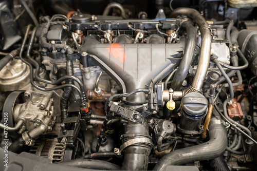 Checking and repairing an internal combustion engine in an auto repair shop.