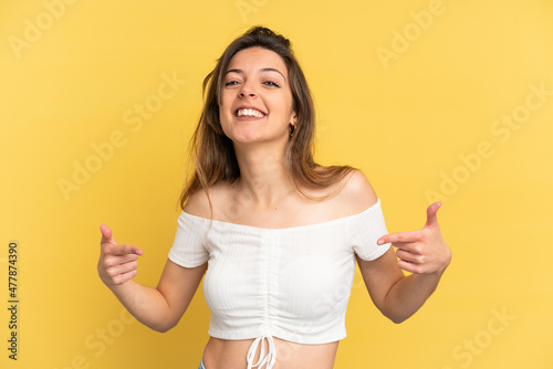 Young caucasian woman isolated on yellow background proud and self-satisfied