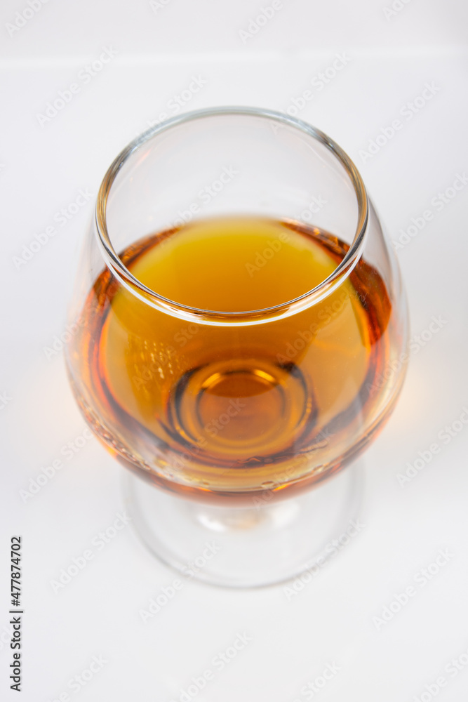 glass with cognac on a white background glass with cognac on a white background