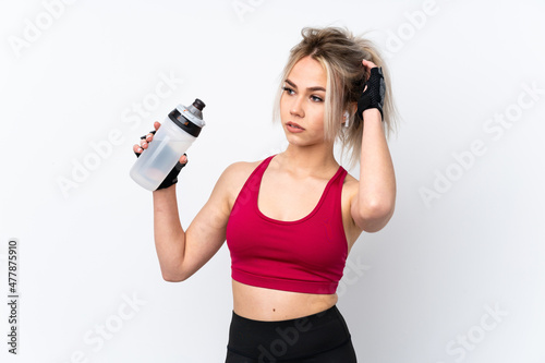 Teenager girl holding waffles over isolated blue background with sports water bottle