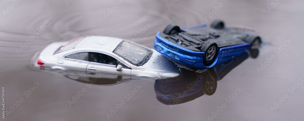The cars were flooded, one car is parked above the other. One of them is out of focus.