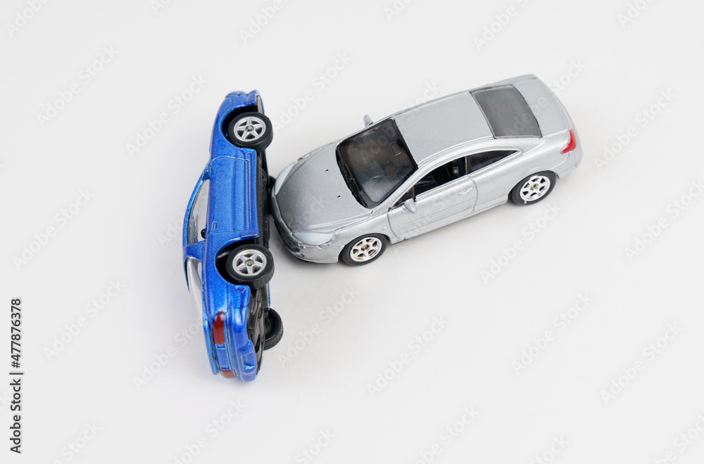Collision of silver and blue toy cars. Isolated on white background. Collision of silver and blue toy cars. Isolated on white background.