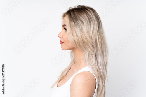 Teenager blonde girl over isolated white background . Portrait