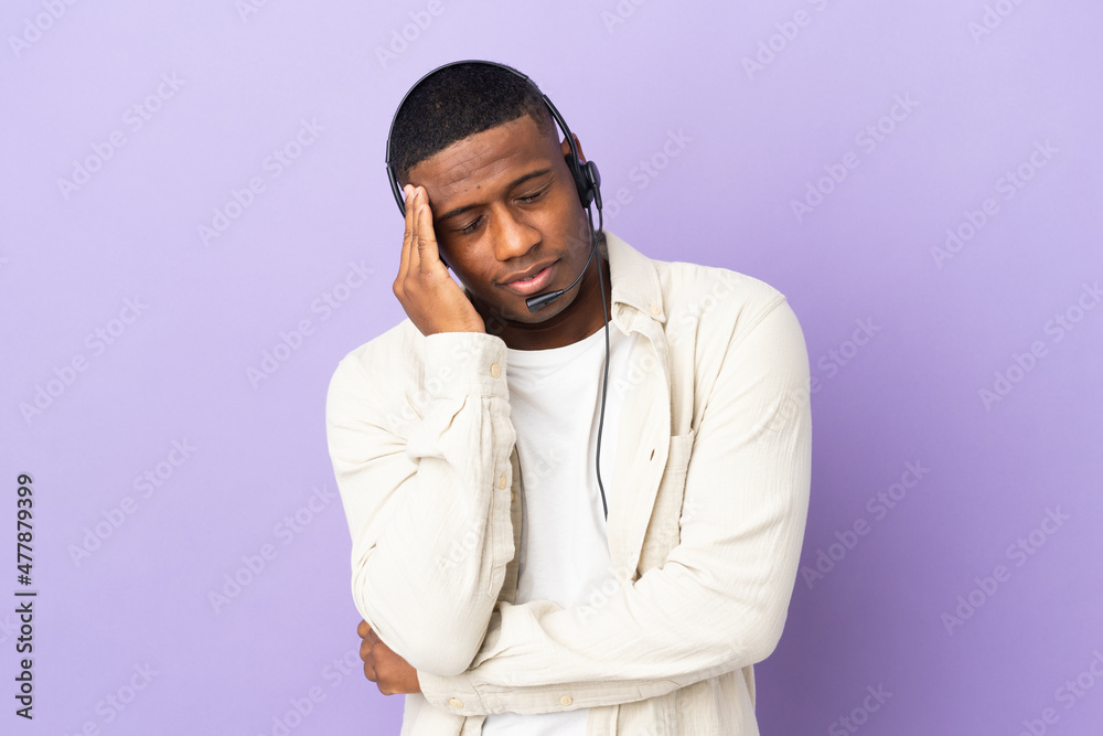 Telemarketer latin man working with a headset isolated on purple background with headache
