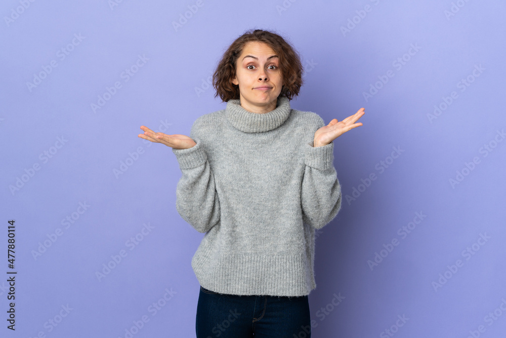 Young English woman isolated on purple background making doubts gesture Young English woman isolated on purple background making doubts gesture
