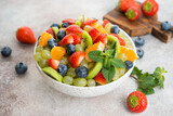 Fruit salad of blueberries, strawberries, grapes and kiwi in a plate
