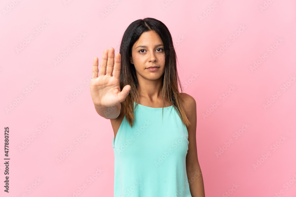 Caucasian girl isolated on pink background making stop gesture Caucasian girl isolated on pink background making stop gesture
