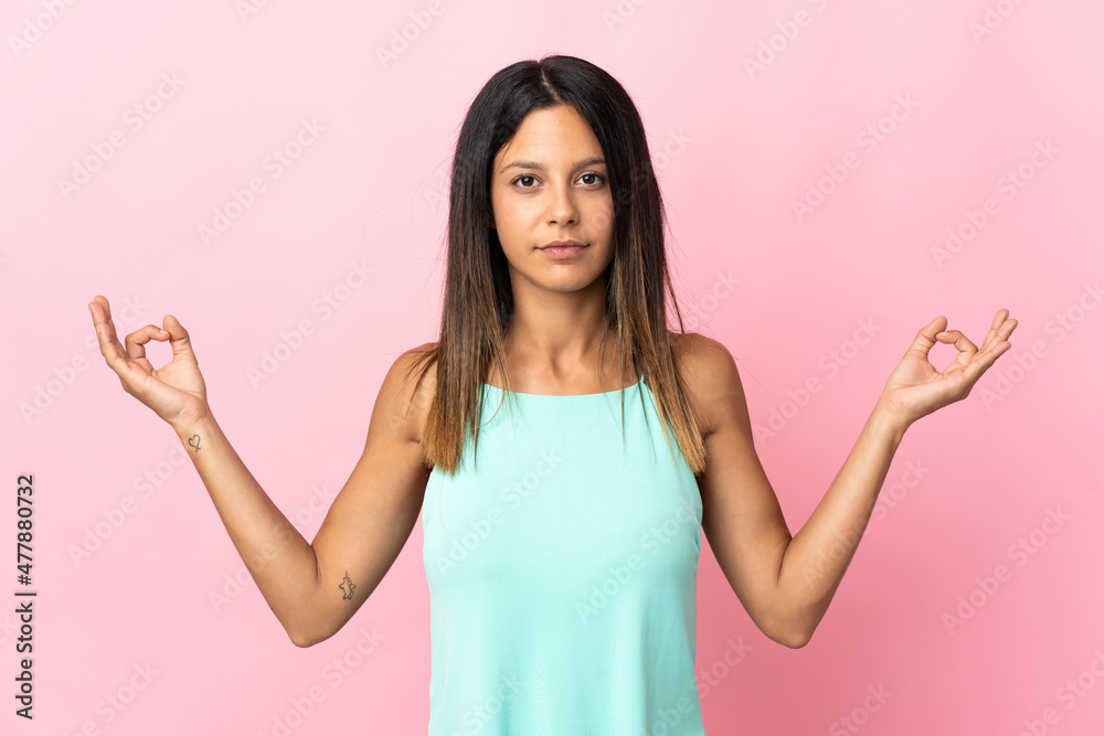 Caucasian girl isolated on pink background in zen pose Caucasian girl isolated on pink background in zen pose