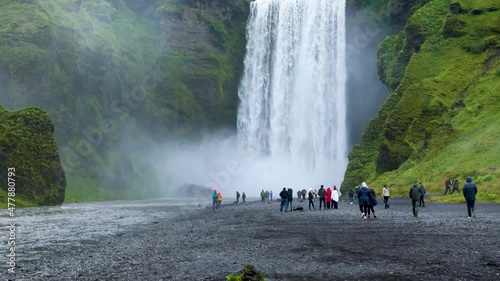 Reykjavik, Iceland - August 26th 2021: beautiful view of an Icelandic water fall during a cloudy day. The Skogafoss waterfall is a tourist attraction that brings in many visitors