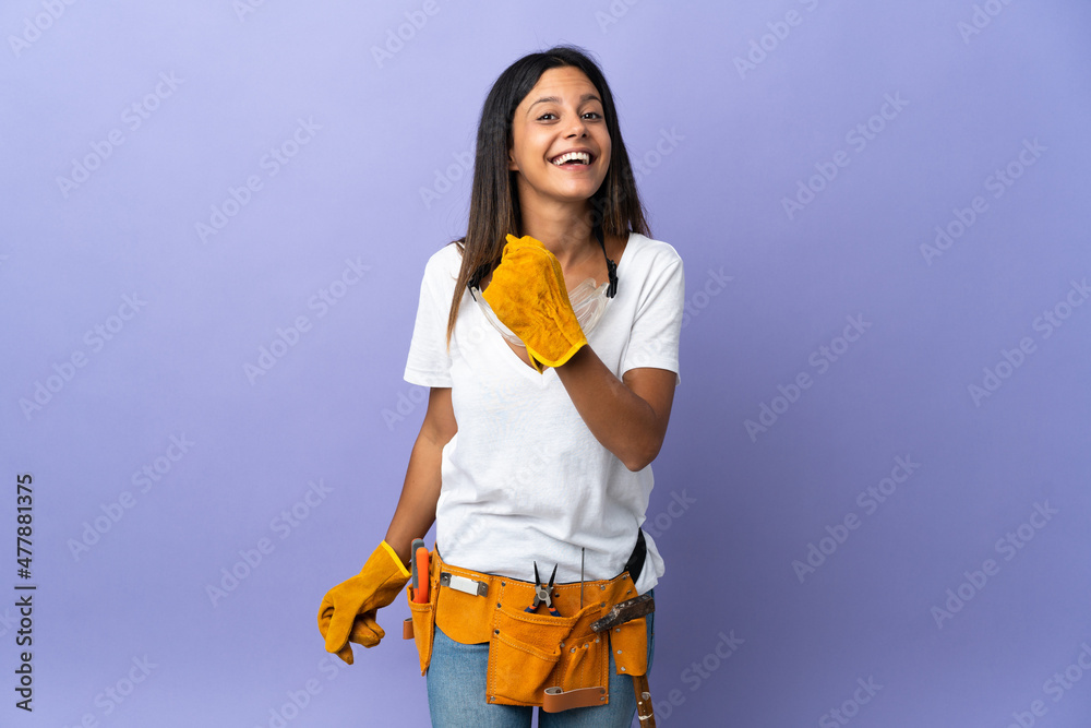 Young electrician woman isolated on purple background celebrating a victory Young electrician woman isolated on purple background celebrating a victory