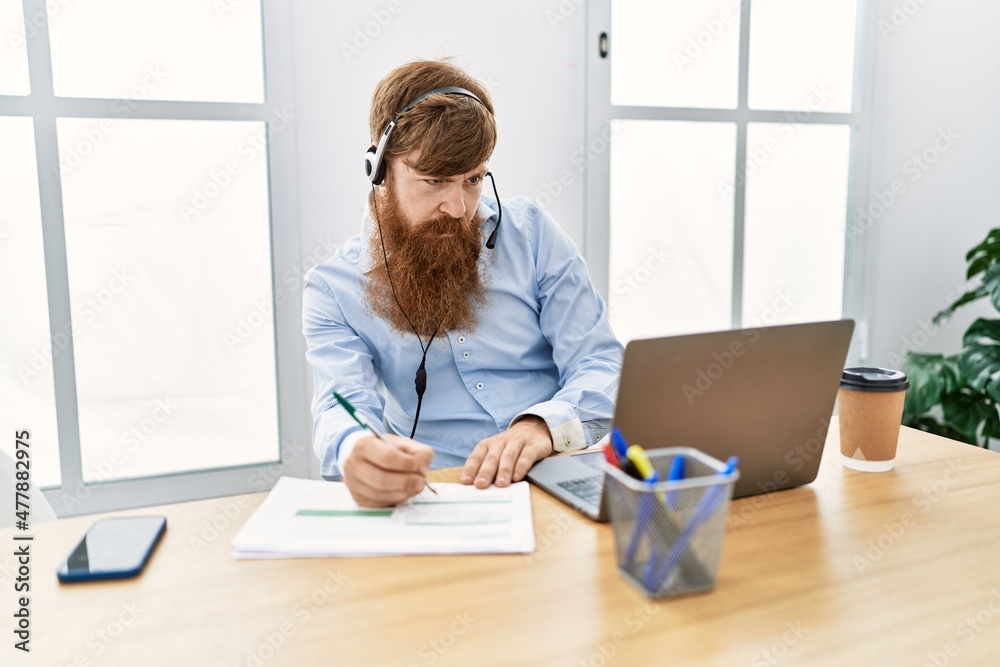 Young irish call center agent concentrate working at the office.