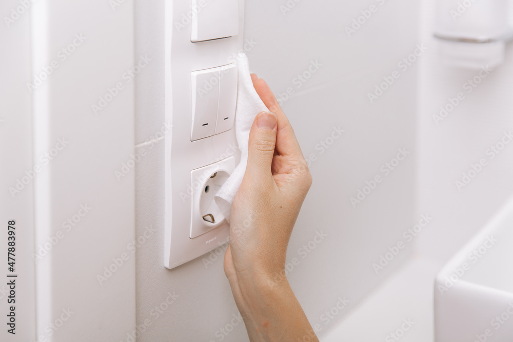 Cleaning switches and sockets with a microfiber cloth. Sanitize
