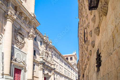 Architecture in Salamanca, Spain; view of the Casa de las Conchas and a Baroque church in the background photo