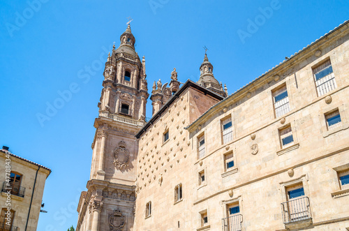 Architecture in Salamanca, Spain; view of the Casa de las Conchas and a Baroque church in the background