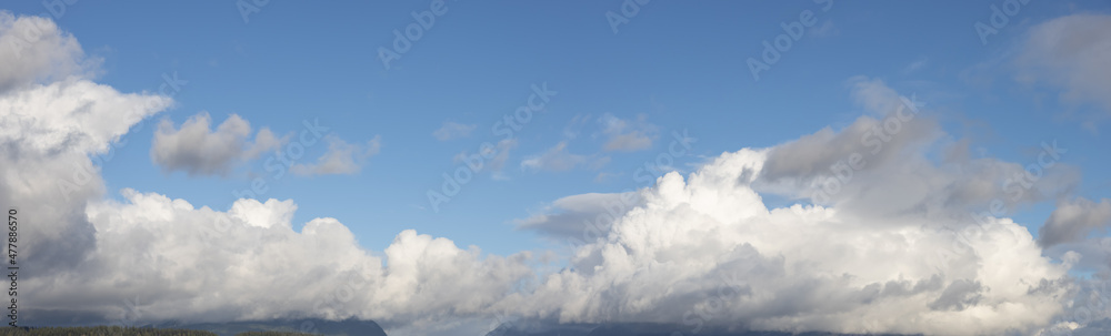 Panoramic View of Cloudscape during a cloudy blue sky sunny day. Taken on the West Coast of British Columbia, Canada.