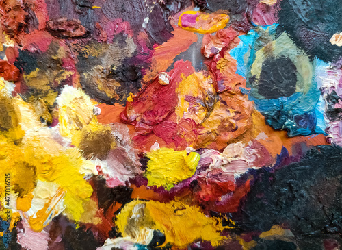 Palette with oil paints - colored background