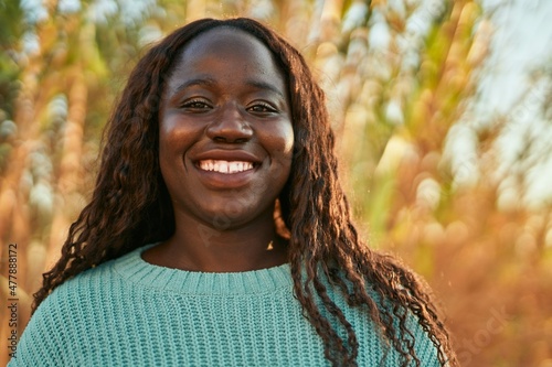 Young african woman smiling happy at the park