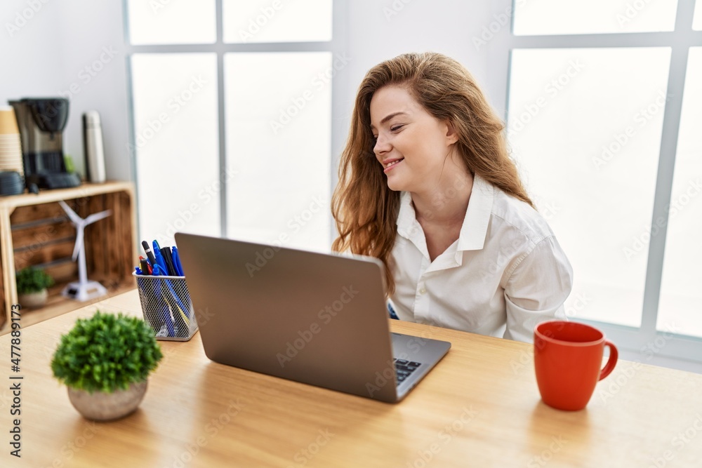 Young caucasian woman working at the office using computer laptop suffering of backache, touching back with hand, muscular pain Young caucasian woman working at the office using computer laptop suffering of backache, touching back with hand, muscular pain