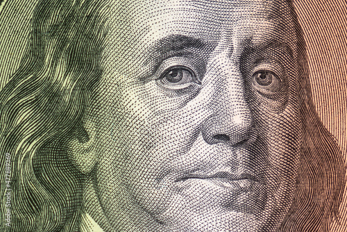 Dollar USA close-up. Franklin eyes and face macro. USD banknote texture. One hundred American dollars. $ 100.