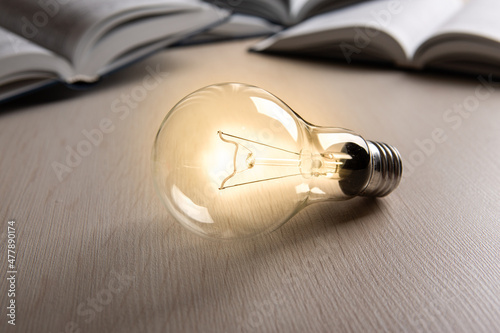 burning glass bulb on the background of books search for ideas photo