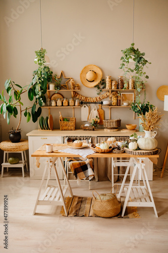 interior of kitchen is made of wood with elements of eco style. autumn decor. 