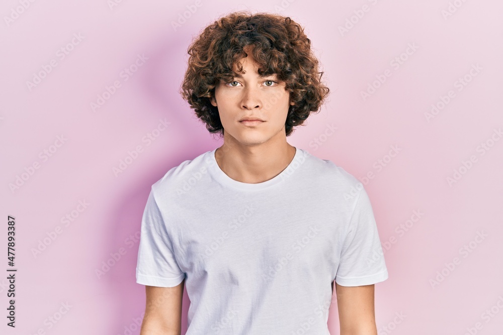 Handsome young man wearing casual white t shirt skeptic and nervous, frowning upset because of problem. negative person. Handsome young man wearing casual white t shirt skeptic and nervous, frowning upset because of problem. negative person.