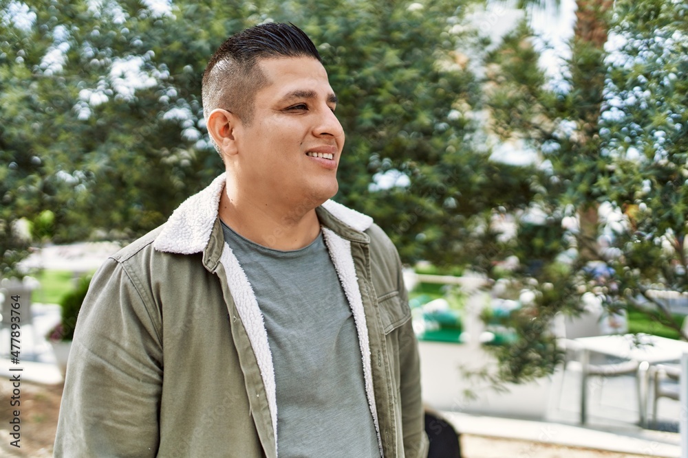 Young latin man smiling happy standing at the city. Young latin man smiling happy standing at the city.