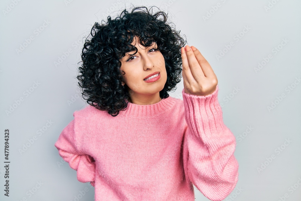 Young middle east woman wearing casual clothes doing italian gesture with hand and fingers confident expression Young middle east woman wearing casual clothes doing italian gesture with hand and fingers confident expression