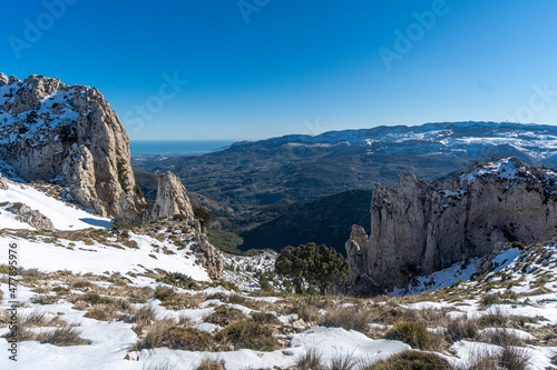 Landscape snowy sunny in la Serrella mountain and Aitana mountain and the sea in the background in Alicante, Spain