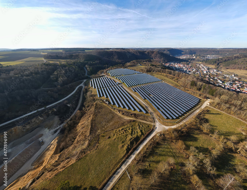Solar-park next to the rural town - Gerhausen, South Germany, Baden-Wuerttemberg, Aerial panoramic view.