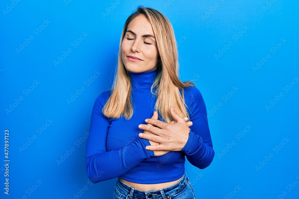 Fototapeta premium Young caucasian woman wearing casual clothes smiling with hands on chest, eyes closed with grateful gesture on face. health concept.